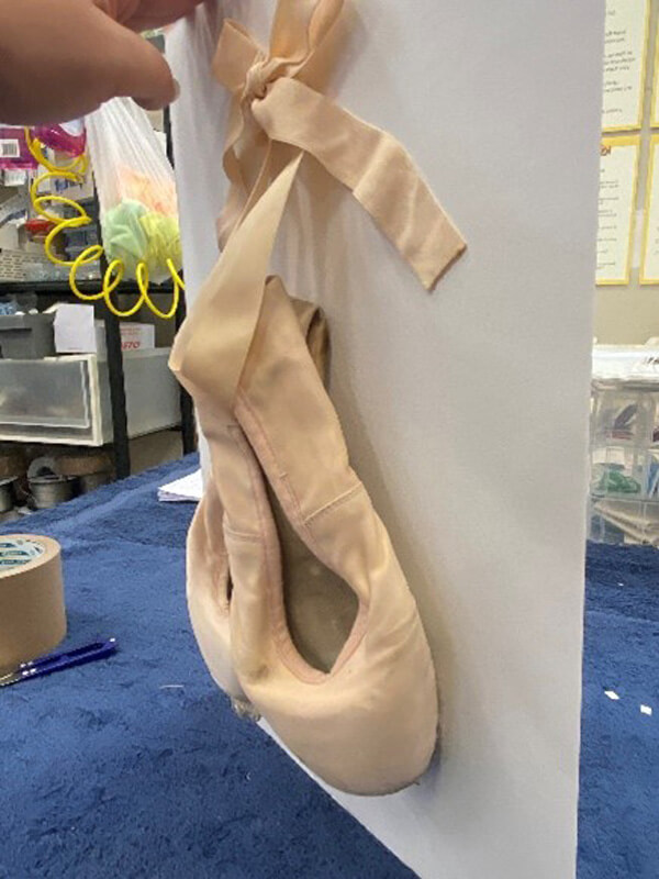 ballet shoes hung on matboard ballet shoes