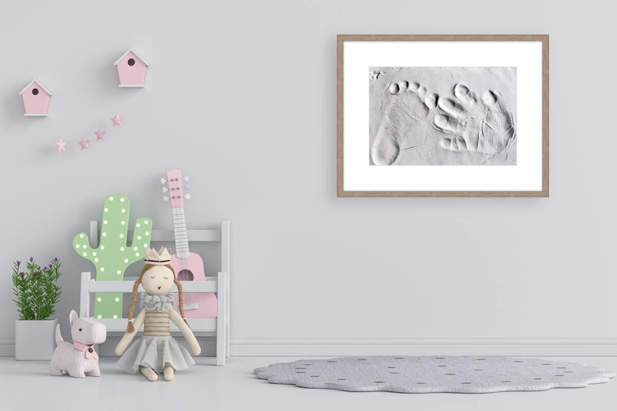 Baby foot prints and hand prints in clay framed and on display